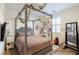 Charming bedroom with a four-poster bed decorated with vines and lights and a plush, textured bedspread at 472 Cadence View Way, Henderson, NV 89011
