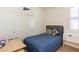Cozy bedroom with a single bed, a wood headboard, sliding closet doors, and a light-filled window at 472 Cadence View Way, Henderson, NV 89011