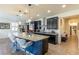 The kitchen boasts dark cabinets, a large island with seating, and stainless steel appliances at 472 Cadence View Way, Henderson, NV 89011