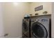 Efficient laundry room with modern front-load washer and dryer, and storage shelf at 472 Cadence View Way, Henderson, NV 89011