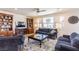 Comfortable living room with plush sofas, a detailed rug, and built-in bookshelves at 472 Cadence View Way, Henderson, NV 89011