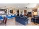 Open-concept living room featuring a large island kitchen with stainless steel appliances and tile flooring at 472 Cadence View Way, Henderson, NV 89011