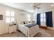 Cozy bedroom features two large windows, a ceiling fan, and a comfortable bed at 472 Cadence View Way, Henderson, NV 89011