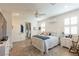 Bedroom features a ceiling fan, two large windows, and neutral paint at 472 Cadence View Way, Henderson, NV 89011