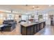 Open-concept living area with an island kitchen, a casual dining area, and a comfortable living room at 472 Cadence View Way, Henderson, NV 89011