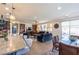 Open-concept living area with a kitchen island, dining area, and living room with a built-in bookshelf at 472 Cadence View Way, Henderson, NV 89011