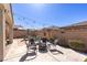 Cozy backyard patio with string lights and comfortable seating around a fire pit, perfect for outdoor gatherings at 472 Cadence View Way, Henderson, NV 89011