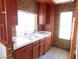 Well-lit kitchen featuring brick accent wall, ample counter space, and classic cabinets at 4855 S Torrey Pines Dr # 102, Las Vegas, NV 89103