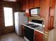 Functional kitchen with essential appliances, brick accent wall, and ample cabinet storage at 4855 S Torrey Pines Dr # 102, Las Vegas, NV 89103