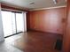 Living room featuring wood-look flooring, fireplace, and sliding glass door with backyard access at 4855 S Torrey Pines Dr # 102, Las Vegas, NV 89103