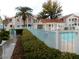 Community pool area with lush landscaping and comfortable lounge space at 4855 S Torrey Pines Dr # 102, Las Vegas, NV 89103