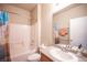 Well-lit bathroom featuring a shower-tub combo, toilet, and single granite vanity sink at 5863 Corbin Ave, Las Vegas, NV 89122