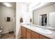 Bright bathroom with dual sinks, spacious counter, walk-in shower, and closet access at 5863 Corbin Ave, Las Vegas, NV 89122