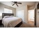 This bedroom has plush carpeting, a ceiling fan, and includes an ensuite bathroom at 5863 Corbin Ave, Las Vegas, NV 89122