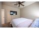 Cozy bedroom featuring a ceiling fan and a mounted flat screen television at 5863 Corbin Ave, Las Vegas, NV 89122