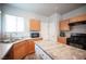 Kitchen featuring wood cabinets, stainless sink, and black appliances at 5863 Corbin Ave, Las Vegas, NV 89122