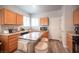 Well-lit kitchen features wood cabinets and a functional island with barstool seating at 5863 Corbin Ave, Las Vegas, NV 89122