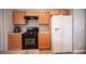Kitchen featuring wood cabinets, updated countertops, and white refrigerator at 5863 Corbin Ave, Las Vegas, NV 89122