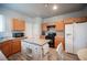 Kitchen featuring wood cabinets, kitchen island, and white appliances at 5863 Corbin Ave, Las Vegas, NV 89122