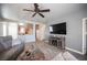 Cozy living room with a ceiling fan, entertainment center, and open access to the kitchen at 5863 Corbin Ave, Las Vegas, NV 89122