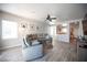 Bright living room with modern furniture, wood flooring, and access to the kitchen at 5863 Corbin Ave, Las Vegas, NV 89122