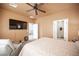 The main bedroom has an ensuite bath, ceiling fan, and mounted television at 5863 Corbin Ave, Las Vegas, NV 89122