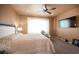 This spacious main bedroom has a ceiling fan, television, and lots of natural light at 5863 Corbin Ave, Las Vegas, NV 89122