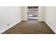 Bedroom with brown carpet and a sliding door to the backyard at 6628 Silver Penny Ave, Las Vegas, NV 89108