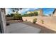 Low maintenance xeriscape backyard with patio, block wall, gravel, and palm trees at 7858 Nookfield Dr, Las Vegas, NV 89147
