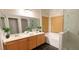 Bathroom featuring double sinks, wood cabinets, soaking tub, and frameless glass shower at 7858 Nookfield Dr, Las Vegas, NV 89147