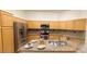 Well-equipped kitchen with granite countertops, stainless steel appliances, and ample cabinet space at 7858 Nookfield Dr, Las Vegas, NV 89147