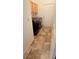 Functional laundry room features modern appliances, tile flooring, and convenient storage cabinets at 7858 Nookfield Dr, Las Vegas, NV 89147
