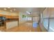 Bright living space open to the kitchen featuring hardwood floors, ample lighting, and stainless steel appliances at 7858 Nookfield Dr, Las Vegas, NV 89147