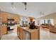 Kitchen includes stainless appliances, tile countertops and backsplash, and breakfast bar with view to living room at 8427 Green Mesa Ct, Las Vegas, NV 89147