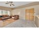 Comfortable living room featuring tile and wood flooring, bright windows, and seamless transition to the kitchen at 8427 Green Mesa Ct, Las Vegas, NV 89147