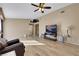 Open-concept living room featuring wood flooring, ceiling fan and natural light at 8427 Green Mesa Ct, Las Vegas, NV 89147