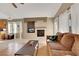 Cozy living room featuring a fireplace, bright windows, tile and wood flooring, and a comfortable sofa at 8427 Green Mesa Ct, Las Vegas, NV 89147