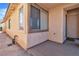 Exterior view of the front porch showcasing window and stucco wall with brown trim at 8453 Garnet Peak Ct, Las Vegas, NV 89117