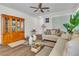 Bright living room featuring wood floors, a ceiling fan, and comfortable sofa at 8453 Garnet Peak Ct, Las Vegas, NV 89117