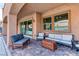 Cozy covered patio featuring brick flooring, ceiling fan, and comfortable outdoor seating at 8834 Sherborne Gate Ave, Las Vegas, NV 89148