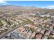 A panoramic aerial view of the neighborhood with mountains on the horizon and city in the background at 9836 La Vid Ct, Las Vegas, NV 89117