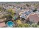 A beautiful aerial view of the backyard, showing a pool, patio and solar panels at 9836 La Vid Ct, Las Vegas, NV 89117