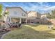 Well-kept backyard showcasing a covered patio, ample lawn space, and established landscaping at 9836 La Vid Ct, Las Vegas, NV 89117