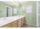 Bright bathroom featuring a double sink vanity, a large mirror, and a neutral color palette at 9836 La Vid Ct, Las Vegas, NV 89117