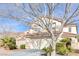 Charming two-story home with a two-car garage and mature landscaping, including palm trees at 9836 La Vid Ct, Las Vegas, NV 89117