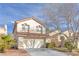 Inviting two-story home with a well-maintained lawn and a convenient two-car garage at 9836 La Vid Ct, Las Vegas, NV 89117
