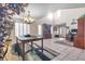 Bright living room with large windows, tile flooring, and elegant chandelier at 9836 La Vid Ct, Las Vegas, NV 89117