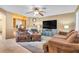Cozy living room featuring a fireplace, built-in shelving, and comfortable seating area with ceiling fan at 9836 La Vid Ct, Las Vegas, NV 89117