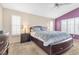 Comfortable main bedroom with a ceiling fan, plantation shutters, and neutral carpeting at 9836 La Vid Ct, Las Vegas, NV 89117