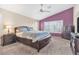 Comfortable main bedroom with a ceiling fan, plantation shutters, and neutral carpeting at 9836 La Vid Ct, Las Vegas, NV 89117